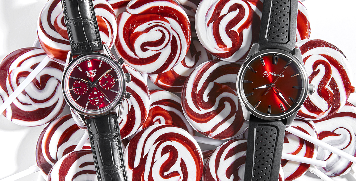 Tag Heuer and H. Moser & Cie watches on top of peppermint swirl lollipops